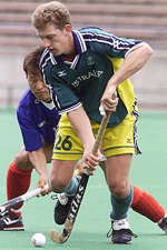 Australian field hockey player Dean Butler (26) keeps possession of the ball from South Korean Hwang Jong-Hyun (rear) in the mens field hockey final match at the East Asian Games in Osaka on Sunday.