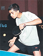 Aditya Puri in action against Sajal. He won the under-14 title by 3-2 in the first Ajit Karam Singh Memorial Open Table Tennis Tournament played at the Sector 23 TT hall in Chandigarh on Sunday. 