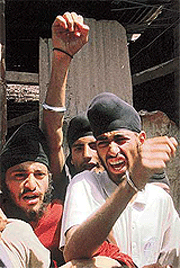 Kashmiri Sikh youths raise slogans against the police during a demonstration in central Srinagar on Sunday.