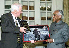 U.S. astronaut Eugene Cernen presents a copy of his book titled The Last Man on the Moon and his photograph to President K.R. Narayanan in New Delhi on Monday.