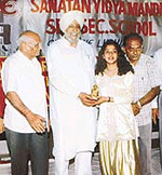 A student receives a prize at a schools annual function in Ludhiana on Tuesday.
