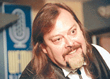 WFMU DJ Glen Jones, 39, smiles inside the broadcast booth at the station in Jersey City, N.J., on Monday, as he set a new record as the host of the longest continuous radio broadcast on record.