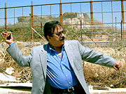 Head of the Egyptian Actrors Union Yousef Shaaban throws a stone towards the Israeli border at Fatima Gate in south Lebanon on Tuesday.