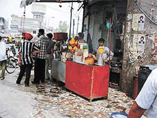 A juice kiosk with its sales counter operates on the pavement outside Dhayan Singh Complex in Ludhiana. 
