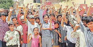Activists of the local unit of the Indian Muslim Council stage a dharna outside the Basti Jodhewal police station on Sunday.