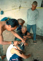 A barber shaves people's heads.