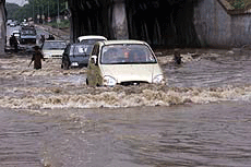 New Delhi : Cars passing through the water logged road in Chanakyapuri Puri area in the capital when heavy shower in the after noon makes Delhi pleasant on Monday.