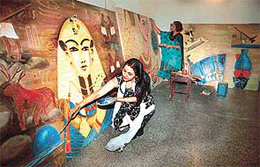 Poonam Diwan and Bharti Sharma give final touches to their painting in Panchkula on Monday. 