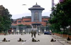 Soldiers and policemen take sniper positions in front of the royal palace.