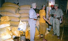 Police officials conduct a raid on a spice factory in Bathinda on Wednesday. 