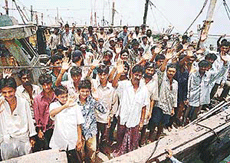 Indian fishermen wave before leaving a Karachi port for India on Thursday. The Pakistani authorities released 157 Indian fishermen who were caught by Pakistan's coast guard from open sea two years ago while fishing in Pakistani territorial water. 
