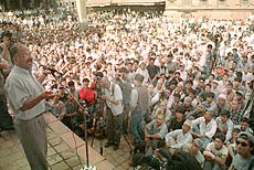 Nepalese Communist former parliamentarian Lilamani Pokhrel (L), addresses a public gathering to demand a fair probe into the June 1 massacre of the Nepalese royal family during a rally in Patan, on the outskirts of Kathmandu Friday. 