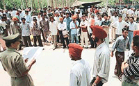 Aspirants for the posts of Home Guards volunteer in the Chandigarh police wait for their turn to undergo a physical fitness test at Police Lines, Sector 26, Chandigarh, on Friday.  