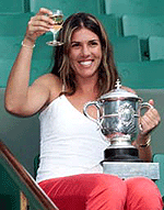 Jennifer Capriati of the US holds up a glass of champagne with her trophy.