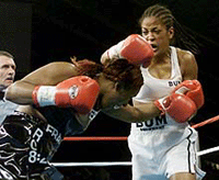 Laila Ali, (R) the 23-year-old daughter of boxing legend Muhammad Ali, lands a blow to the head of 39-year-old Jacqui Frazier, the daughter of boxer Joe Frazier during the 7th round of their bout at Turning Stone Casino in Verona New York, June 8, 2001. 