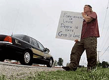 Death penalty opponent Harold Smith, of Albany, N.Y., stands on the road outside the United States Penitentiary in Terre Haute, Indiana, on Sunday.