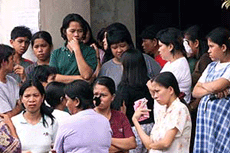 Basilan residents gather in Isabela town after Muslim Abu Sayyaf rebels raided their village and seized 15 new hostages, including children, on Monday. 
