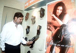 Former Indian Cricketer Kapil Dev inaugurates a shoe outlet in New Delhi on Monday. 