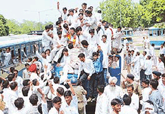 The All-India Youth Congress President, Mr Randeep Singh Surjewala, lends a helping hand to activists to get on top of a vehicle as they court arrest during a rally of the Haryana Youth Congress at Matka Chowk in Sector 17 in Chandigarh on Tuesday. 