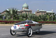 Solar car "Hitomi" of team Hama Zero from Japan races past the Prime Minister's office during the world solar car championship in Putrajaya, 60 kilometres south of Kuala Lumpur on Tuesday. 