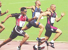 Maurice Greene (right) finishes first, followed by Ato Boldon from Trinidad (left) and Bernard Williams of the USA (centre) .