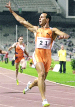 Costas Kenteris from Greece, gold medallist at the Sydney Olympics, raises his arm after winning the 200-metre sprint of the Tsiklitiria Athens Grand Prix 2001 in Athens Olympic Stadium on Monday.