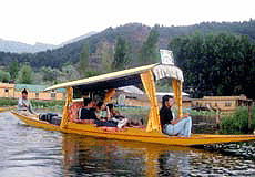A group of domestic tourists enjoying shikara ride in world famous Dal lake in Srinagar. 