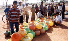 People queue up to get drinking water