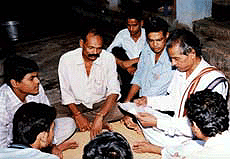 Harrihar Sahooa (2nd R), 67, mediates a dispute for local residents in a temple in Bhubaneswar, Orissa, on Thursday.