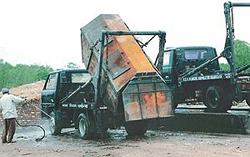 Two tippers of the Municipal Corporation, Chandigarh, being washed at an unauthorised service station at Dadu Majra in Chandigarh on Thursday. 