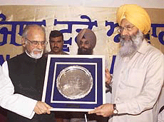 Former Prime Minister I. K. Gujral receiving a punjabi today award from Fertiliser and Chemical Minister S. S. Dhindsa at a function in New Delhi on Friday.