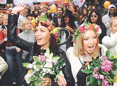 Environmental protesters wearing flowers in their hair sing and chant as they march with hundreds of demonstrators in Gothenburg on Saturday.