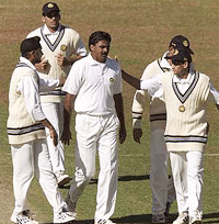 Indian players congratulate bowler Javagal Srinath (C) after he took the last Zimbabwe wicket of Grant Flower for 86 runs 17 June 2001. 