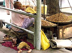 Oh! my sleeping child, the world's so wild but you've built your own paradise ... a child sleeping at a bus shelter unmindful of the sweltering heat.  