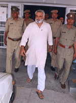 Former Haryana Minister Anand Singh Dangi being escorted out of the Civil Hospital, Ambala City, after he was discharged on Tuesday. 