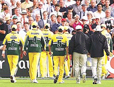 The Australian cricket team leave the field after fireworks exploded in the stand and one was thrown onto the field at Trent Bridge during their match against Pakistan on Tuesday. 