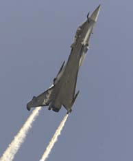 Dassault's Rafale fighter jet leaves a trail of smoke as it climbs over the runway at Le Bourget Air Show, north of Paris, on wednesday. The event attracts over 250,000 spectators during the week.