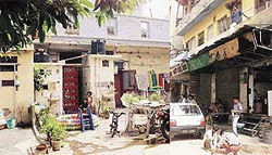 Haveli where General Pervez Musharraf spent his early childhood and (R) street lighting being redone in anticipation of his visit.