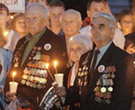 Russian World War II veterans light candles during a pre-dawn ceremony at The Tomb of Unknown Soldier near the Kremlin wall in Moscow on Friday, marking the 60th anniversary of the invasion of the Soviet Union.