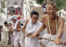 Hindu priests and devotees pull a chariot of gods in an ancient annual festival honouring Lord Jagannath during a break in the curfew in Imphal, capital of Manipur, on Saturday.