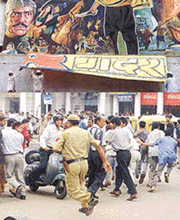 Activists of Ali sena tearing off the banner film "GADAR" at a theater in New Delhi on Sunday.
