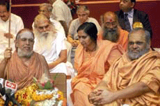 Hindu religious leaders dressed in traditional saffron robes gather for a meeting against female foeticide and infanticide in New Delhi on Sunday.