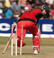 Zimbabwe batsman Brian Strang looks back at his broken wicket after being bowled by India's Ajit Agarkar for 4 runs on Sunday.