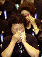 Korean war widows wipe their tears during a ceremony marking the 51st anniversery of the start of the Korean war at Olympic Park in Seoul on Monday. 