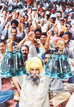 A man raises lanterns to protest against plans to privatise the power industry in India during a demonstration in Chandigarh on Tuesday.