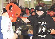 French boxer Julien Lorch (R) exchanges punches with his sparring partner during a training session in a Tokyo gym on Tuesday.