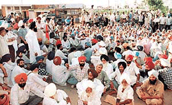 Residents of Siau village block the Chandigarh-Fatehgarh Sahib highway demanding arrest of a Youth Akali Dal leader in connection with the murder of children at Siau village at Sohana on Wednesday. 