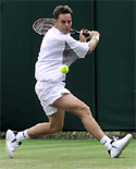 Australia's Todd Woodbridge plays a return to Raemon Sluiter of the Netherlands during their second round match at Wimbledon on Wednesday. 