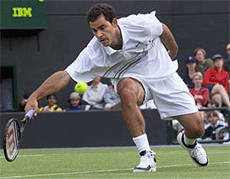 Pete Sampras of the U.S.A. stretches to return a serve from Britain's Barry Cowan during their second round match at Wimbledon on Wednesday.