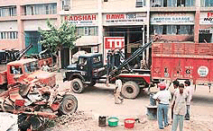Continuing its anti-encroachment drive, a recovery van of the UT Administration lifts a truck from the Motor Market, Mani Majra, on Friday. 